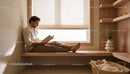 Father Enjoying Quiet Reading Time Near Sleeping Baby