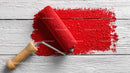 Red Paint Roller Applying Bright Red Paint on Wooden Surface