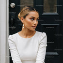 Elegant young woman wearing pearl earrings outdoors