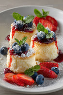 Elegant Cheesecake with Fresh Berries and Mint Garnish