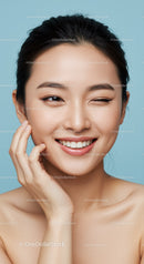 Elegant Asian Woman Smiling with Flawless Skin and Natural Makeup