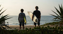 Two Surfers with Surfboards at Beach Ready for Waves