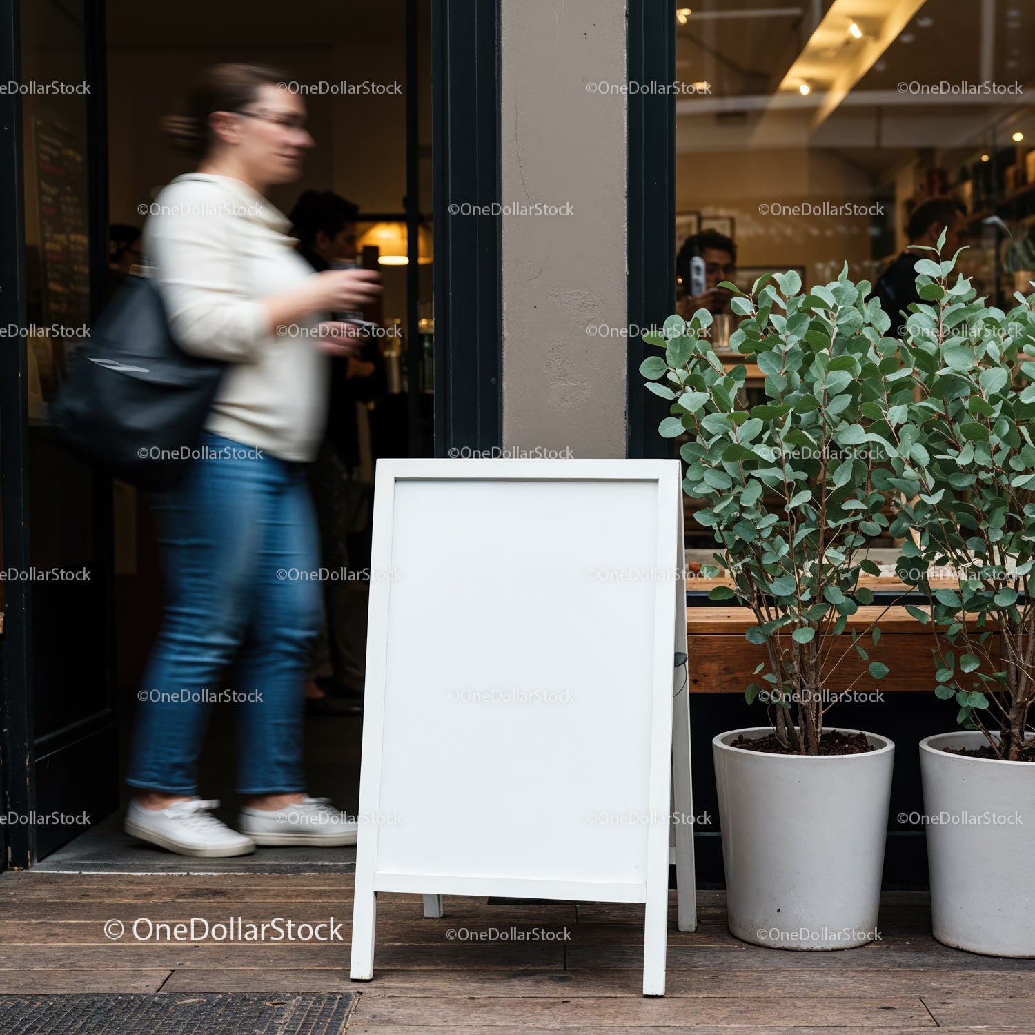 Woman walking past blank cafe sidewalk sign outdoors