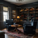 Cozy library corner with leather chairs and warm lighting