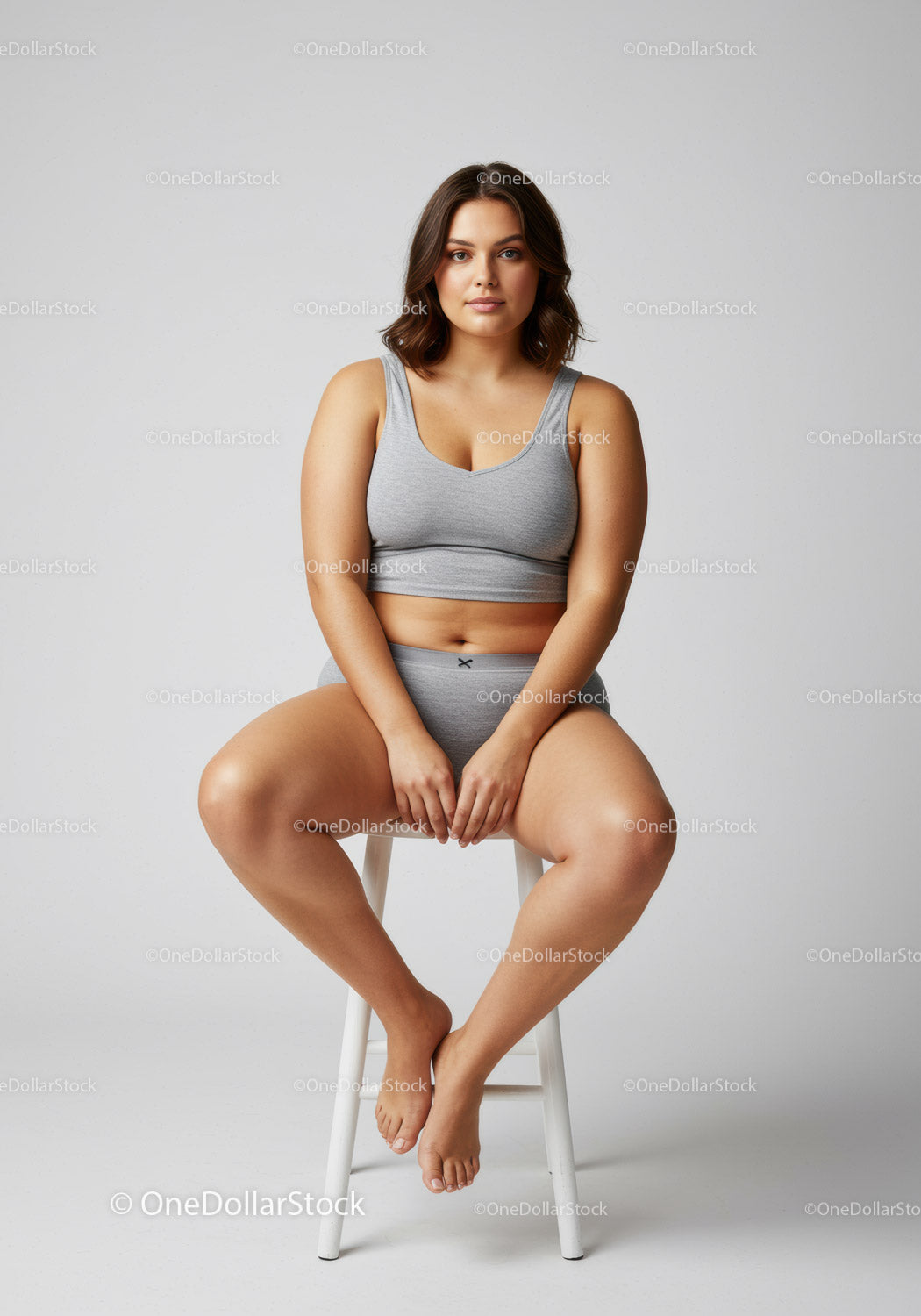 Confident Woman Sitting on Stool in Casual Athletic Attire