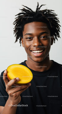 Young Man Holding Mango with Bright Happy Expression in Studio