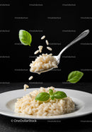 Creamy risotto served with fresh basil leaves