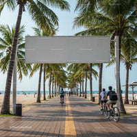 Cyclists riding along palm-lined beachfront promenade