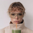 Young Woman with Curly Hair Drinking Green Smoothie Indoor