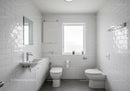 Clean White Bathroom with Ceramic Tiles and Natural Light