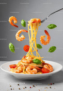 Spaghetti with shrimp basil and cherry tomatoes on plate