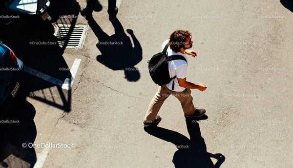 Man walking confidently on sunlit urban street