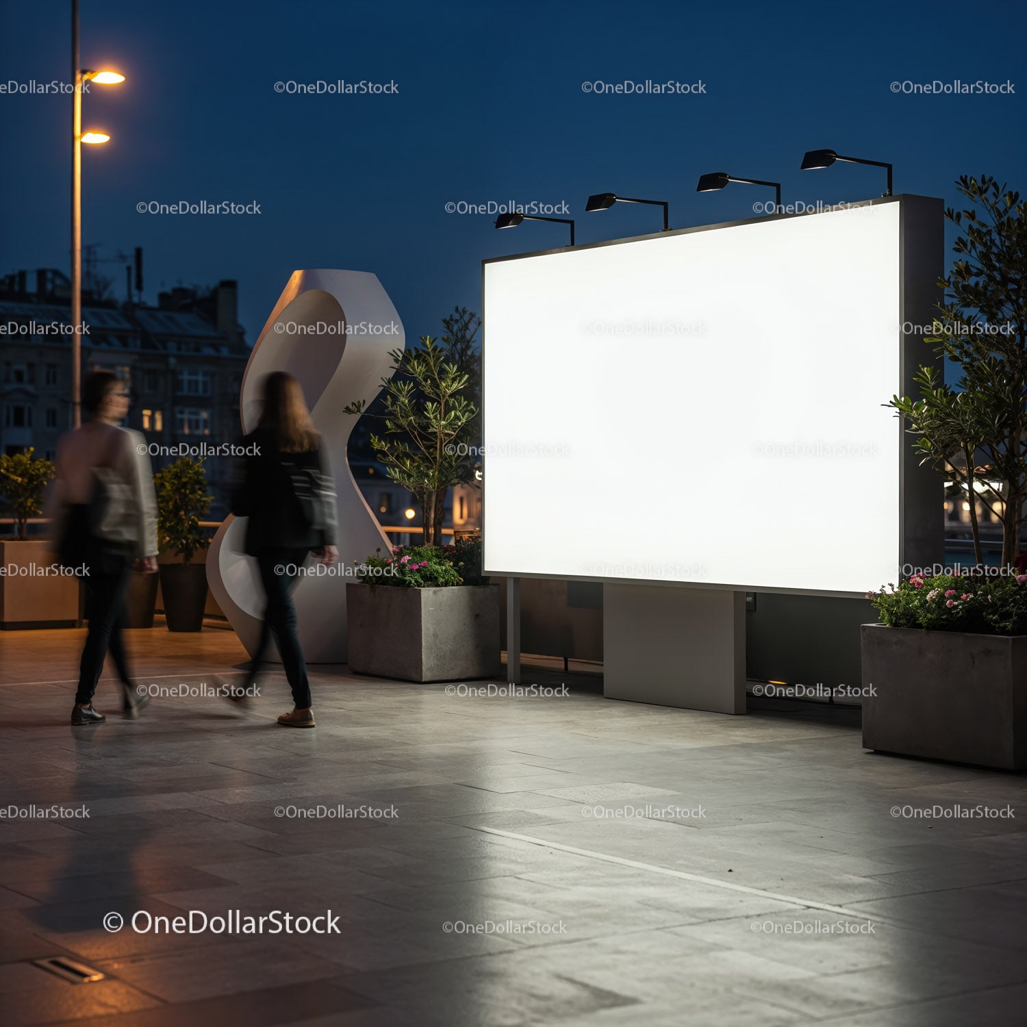 Evening urban scene with large blank illuminated billboard