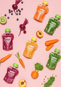 Variety of colorful smoothie pouches with fresh fruits and vegetables