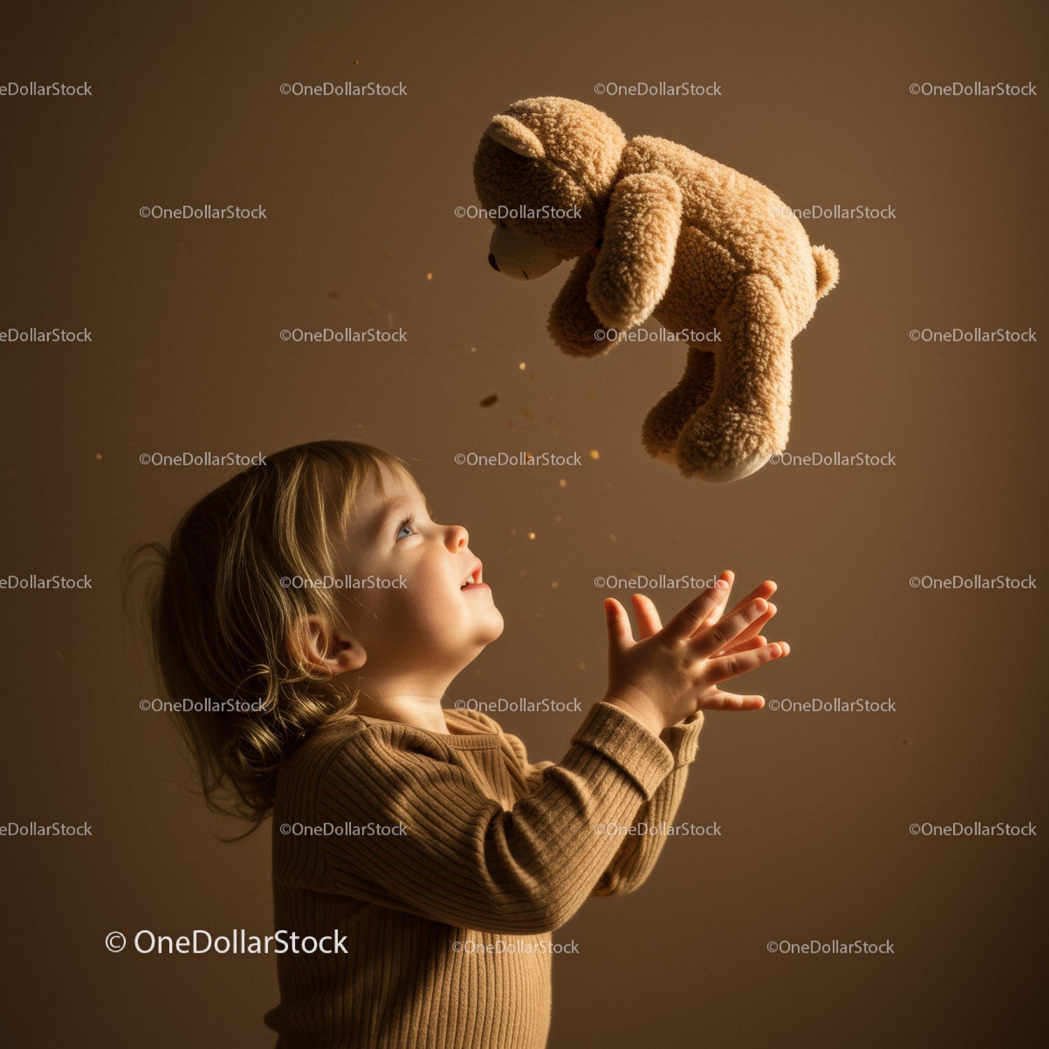 Toddler joyfully catching teddy bear indoors
