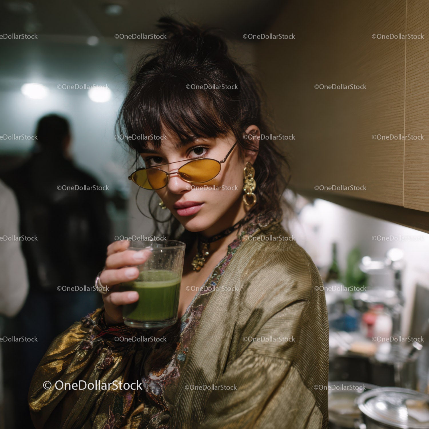 Stylish Young Woman in Gold Blouse with Green Juice and Yellow Sunglasses