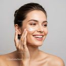 Young Woman Applying Skincare Cream with Smiling Face