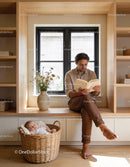 Father Reading Book While Baby Sleeps Peacefully