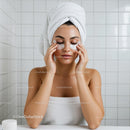 Woman pampering skin with under eye patches at home
