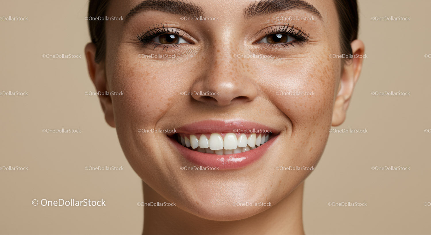 Close up of smiling woman with natural freckles and clear skin