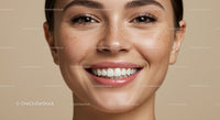 Close up of smiling woman with natural freckles and clear skin
