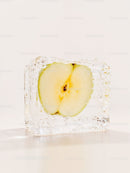 Fresh apple slice preserved inside clear ice cube