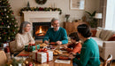 Family enjoying holiday treats by fireplace at Christmas