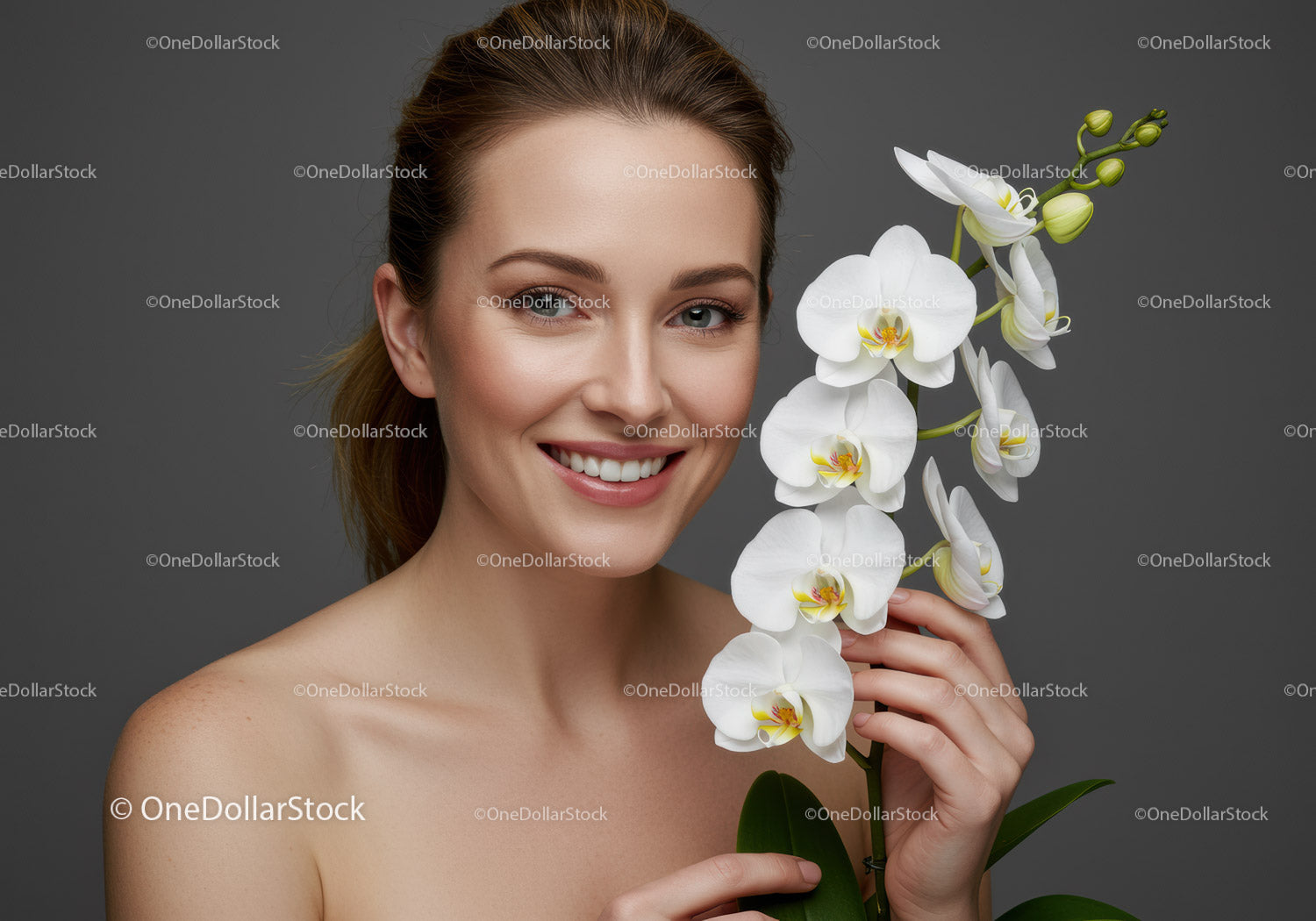 Smiling Woman Holding White Orchid Flower in Front of Gray Background