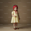 Toddler girl wearing strawberry hat and yellow dress