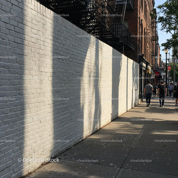 City Sidewalk with Brick Wall and Pedestrians in Urban Environment JPG Mockup Image