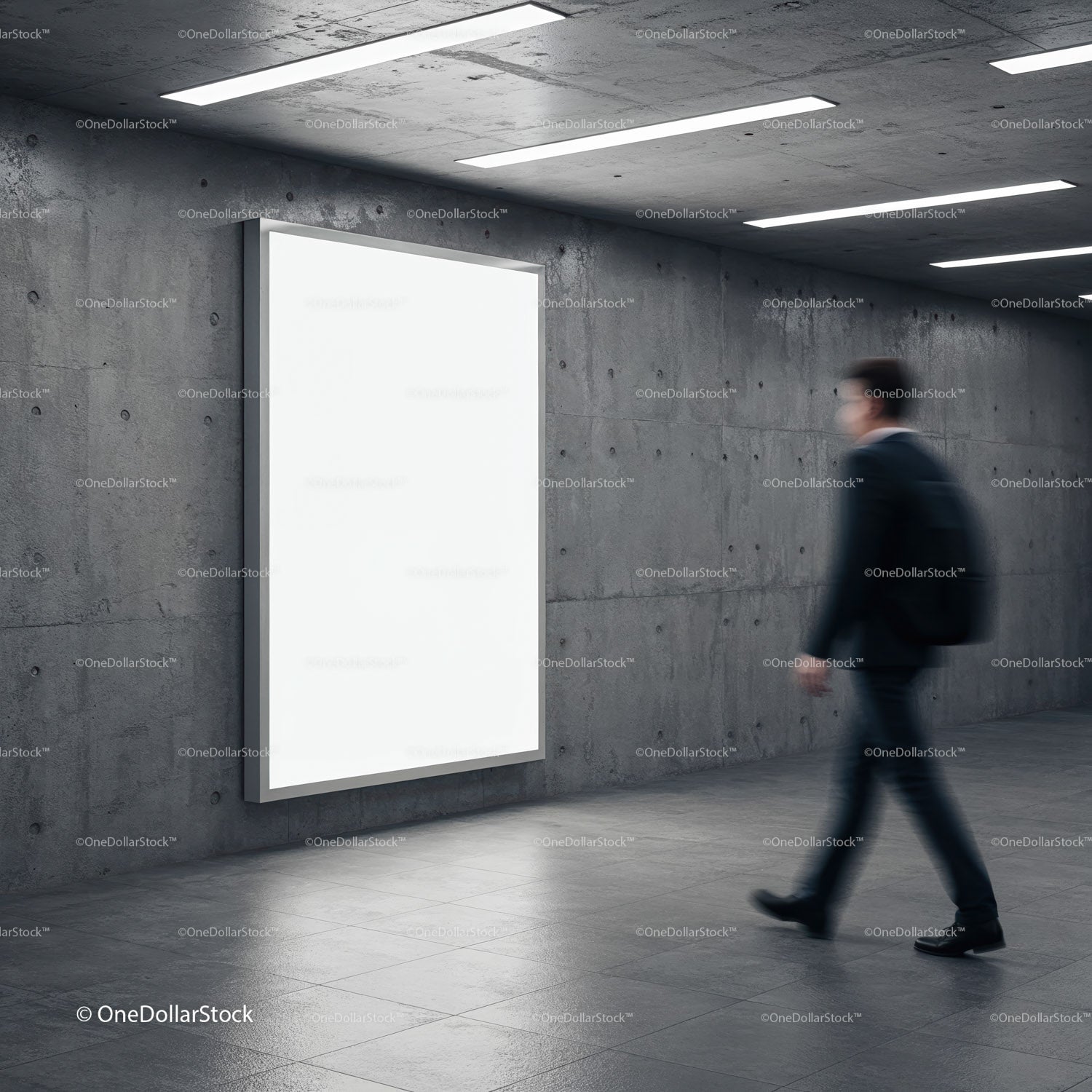 Businessman walking past blank illuminated advertising board