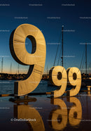 Large illuminated 999 sculpture at harbor dusk