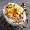 Sliced Hard Boiled Egg with Chili Flakes and Fresh Herbs