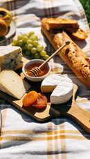 Cheese platter with fresh fruit and honey for picnic