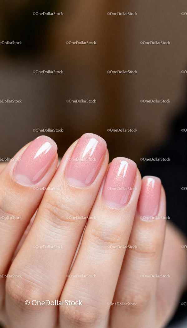 Close up of manicured nails with natural pink polish