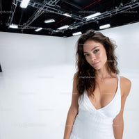 Portrait of a Young Woman in White Dress in Studio with Modern Lighting