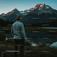 Adventurous Man Enjoying Scenic Mountain Reflection at Sunset