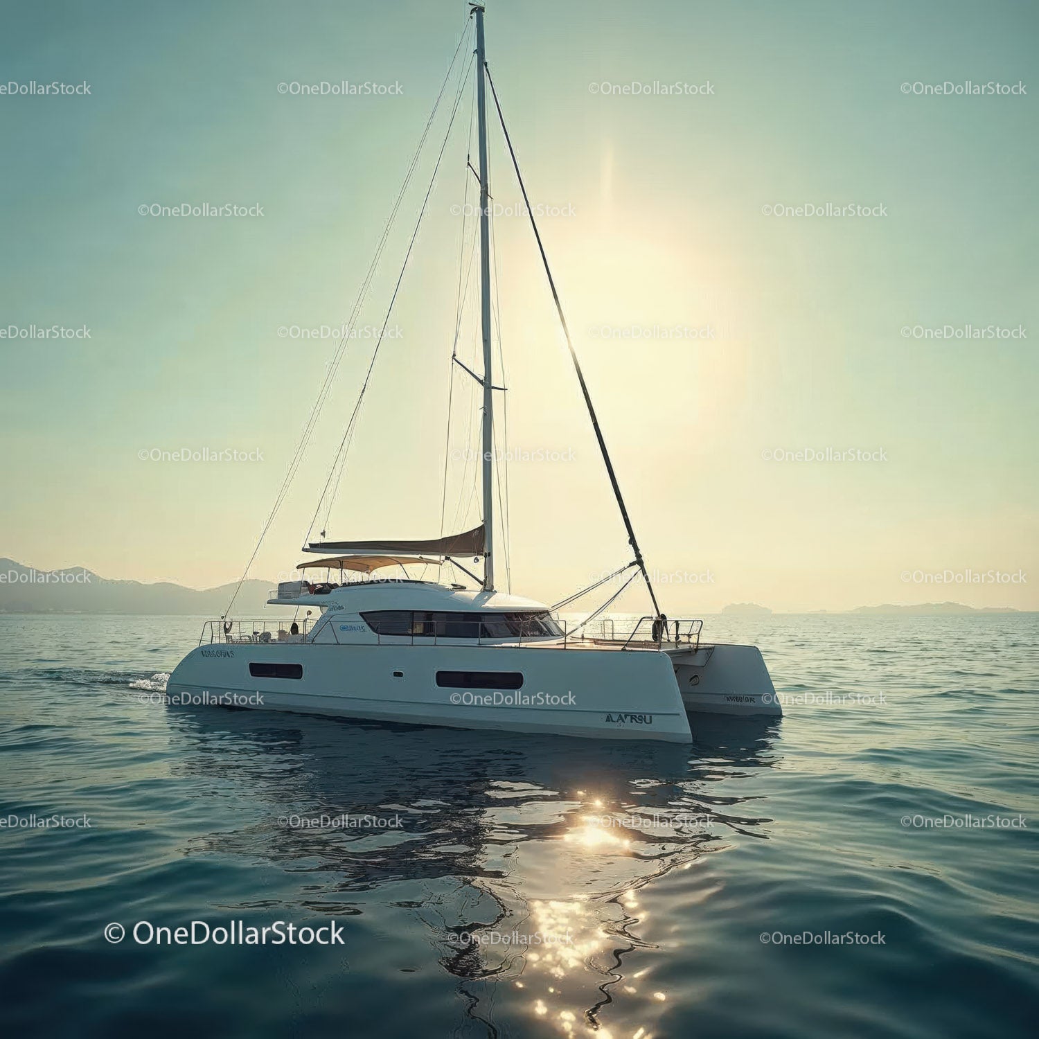 Elegant sailing yacht on calm sea with sunlight reflection