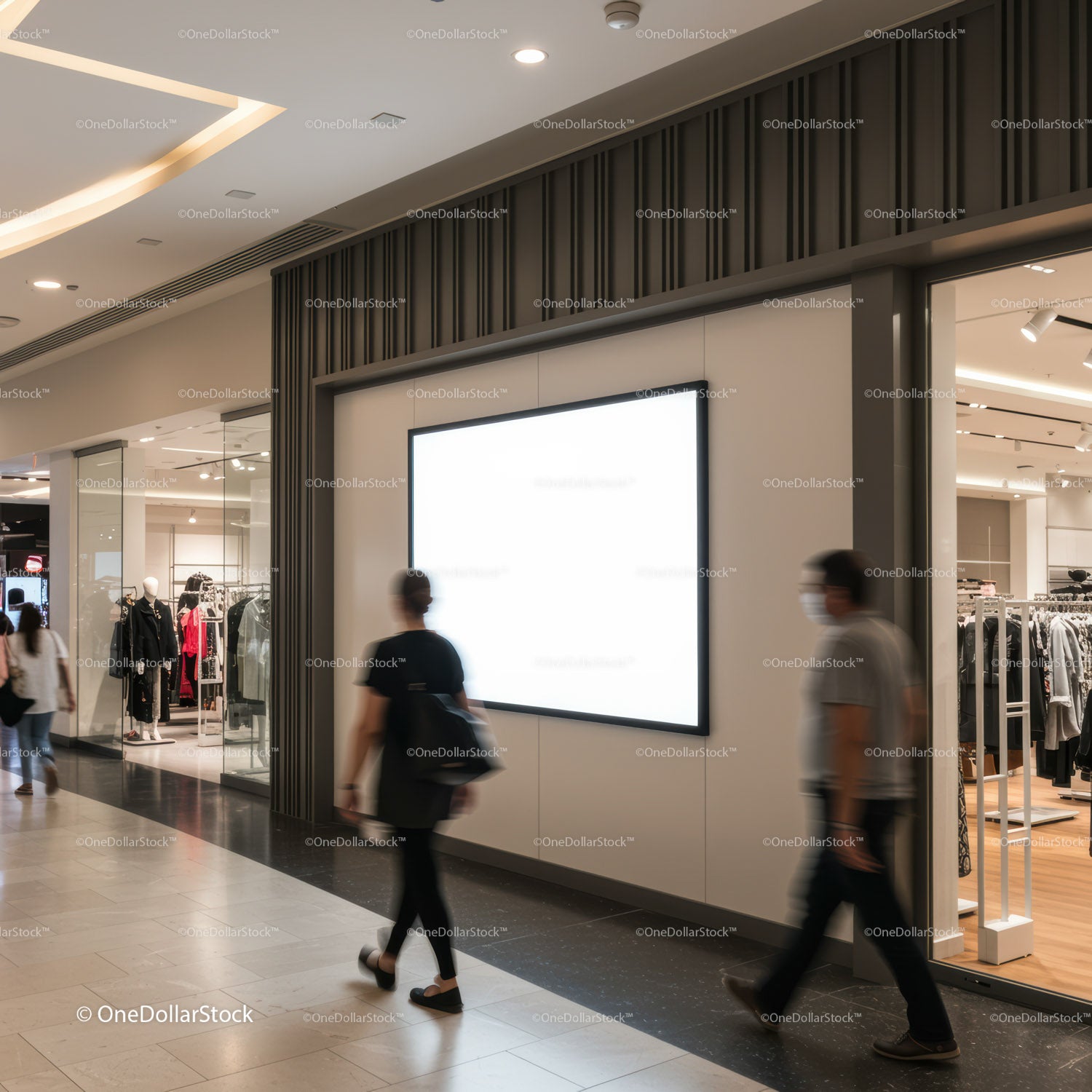 People walking past blank digital billboard in modern mall