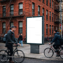 Urban street scene with blank billboard and cyclists