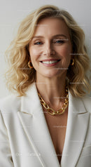 Smiling Blonde Woman Wearing Gold Jewelry in White Blazer