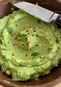 Fresh creamy guacamole with chili flakes and cilantro