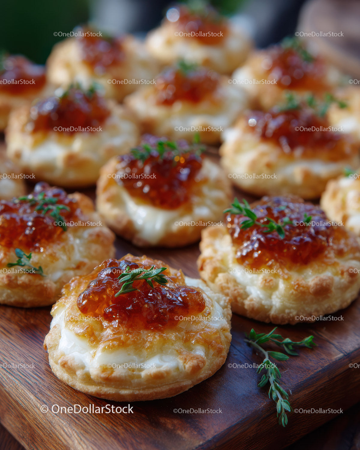 Cheese and Herb Cracker Bites with Jam on Wooden Platter