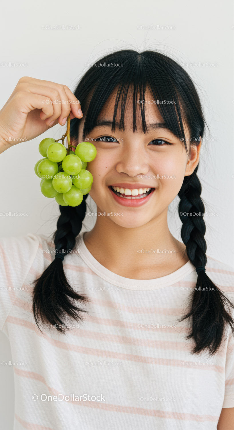 Happy Girl Holding Green Grapes with Bright Smile and Youthful Energy