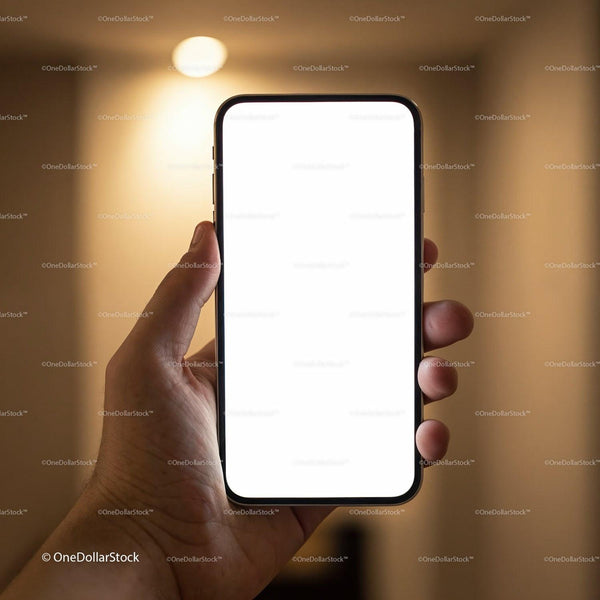 Hand Holding Smartphone with Bright Blank Screen Indoors JPG Mockup Image