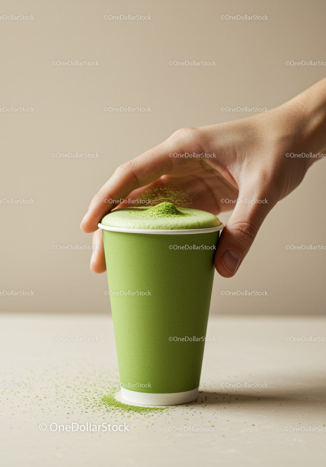 Hand Sprinkling Matcha Powder on Green Tea Latte