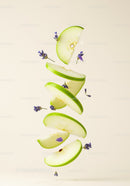 Fresh green apple slices with lavender flowers floating