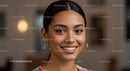 Beautiful Smiling Woman with Elegant Hoop Earrings in Bright Indoor Setting