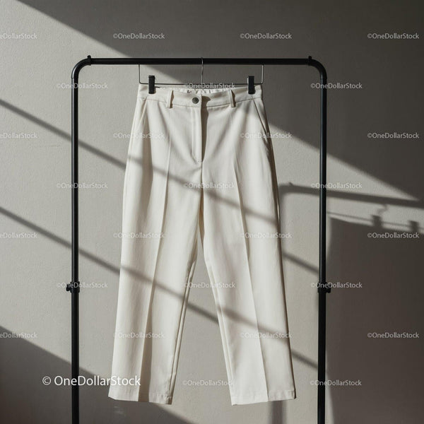 Minimalist white trousers hanging on black rack JPG Mockup Image
