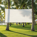 Blank outdoor movie screen hanging between palm trees